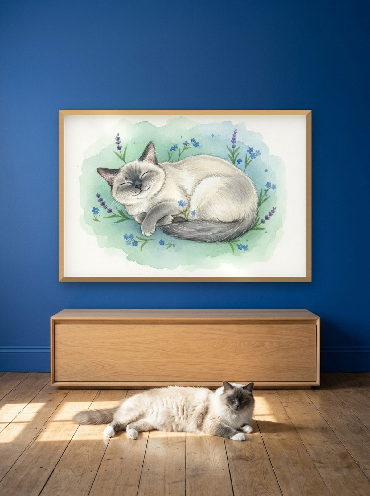 Blue Point - Birman Cat watercolour-style print, framed on the wall above a birman cat in a sunny room (AI-generated photo)