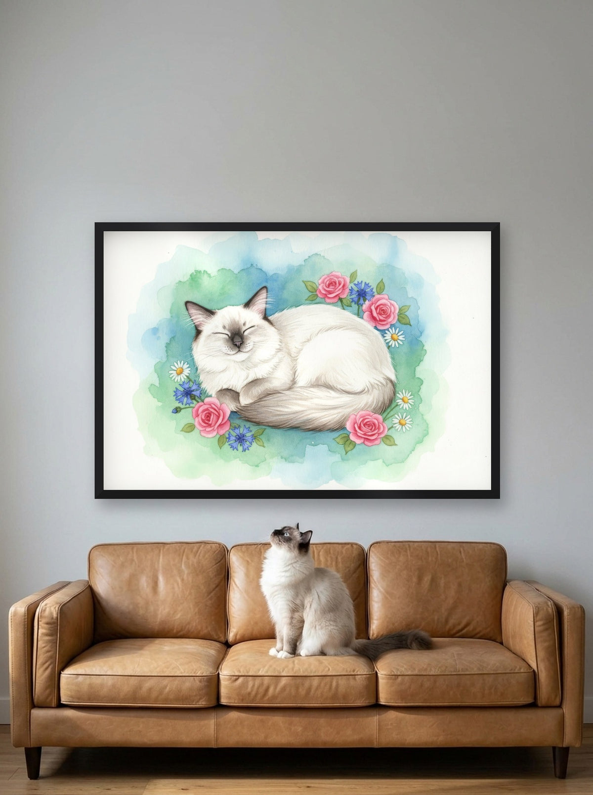 Seal Point - Birman Cat watercolour-style print, framed on the wall above a birman cat on a sofa (AI-generated photo)